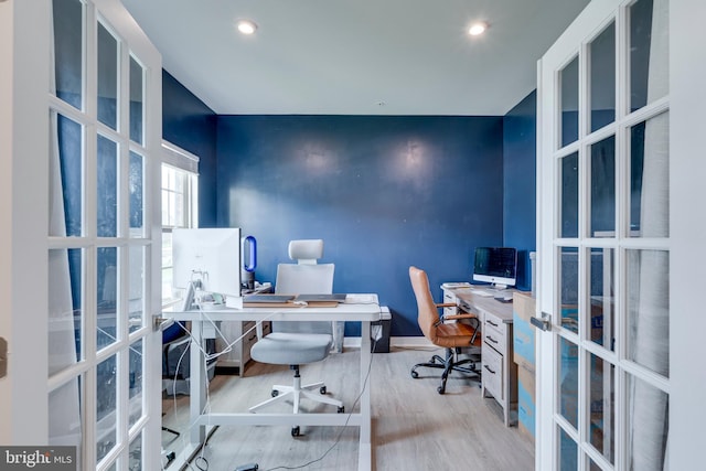 office space with light wood-type flooring and french doors