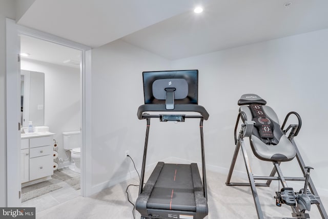 workout room with sink and light colored carpet