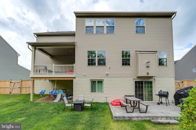 rear view of house featuring a yard and a patio area