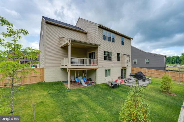 back of house featuring a yard and a patio