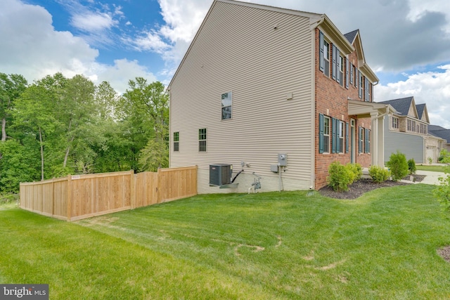 exterior space featuring cooling unit and a yard