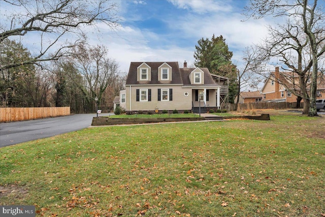 new england style home with a front lawn