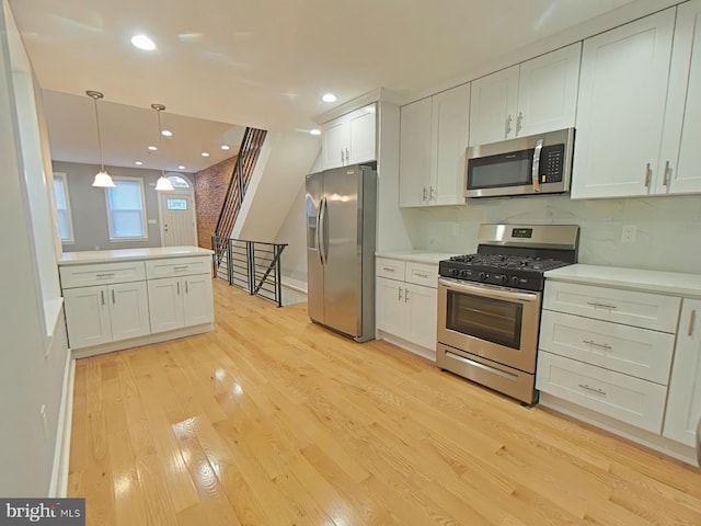 kitchen featuring light hardwood / wood-style flooring, white cabinets, and appliances with stainless steel finishes