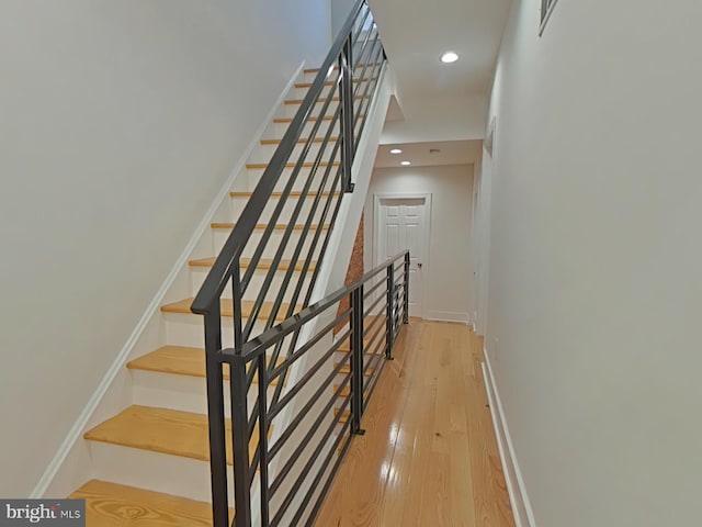 stairs featuring hardwood / wood-style flooring