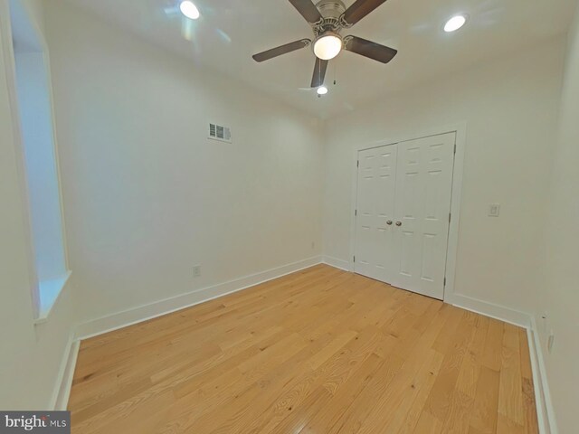 empty room with ceiling fan and light wood-type flooring