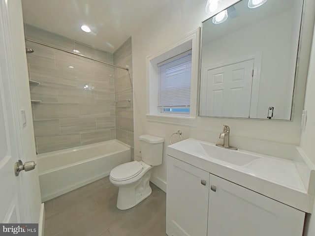 full bathroom featuring vanity, toilet, and tiled shower / bath