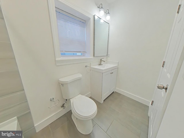 bathroom with tile patterned flooring, vanity, and toilet