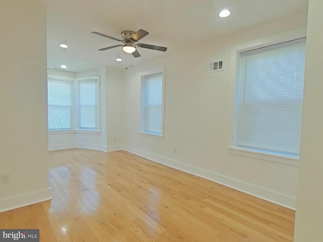 spare room featuring light hardwood / wood-style flooring and ceiling fan