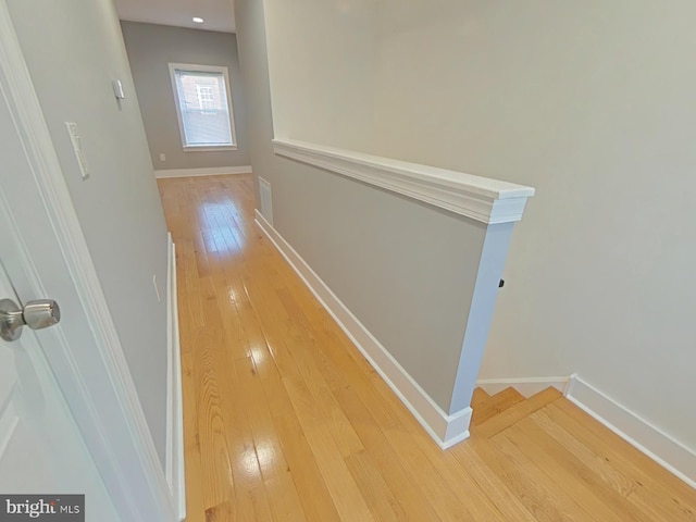 hall with wood-type flooring