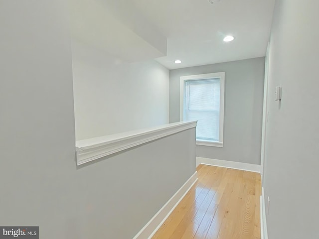 corridor with light hardwood / wood-style flooring