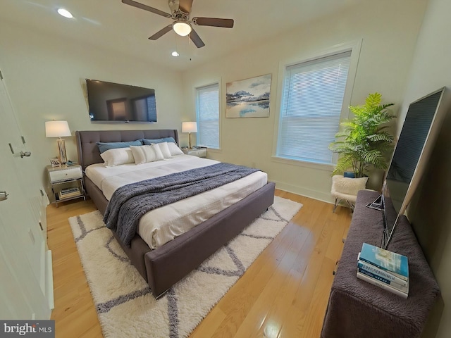 bedroom with ceiling fan and light hardwood / wood-style flooring