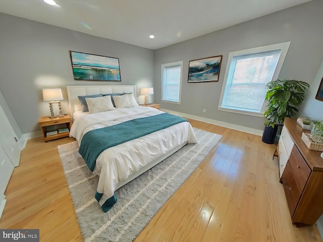 bedroom featuring light wood-type flooring and multiple windows