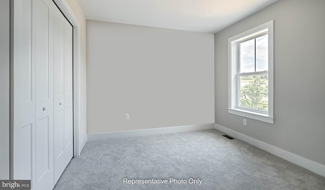 unfurnished bedroom with carpet floors and a closet