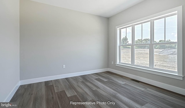 unfurnished room featuring dark hardwood / wood-style flooring