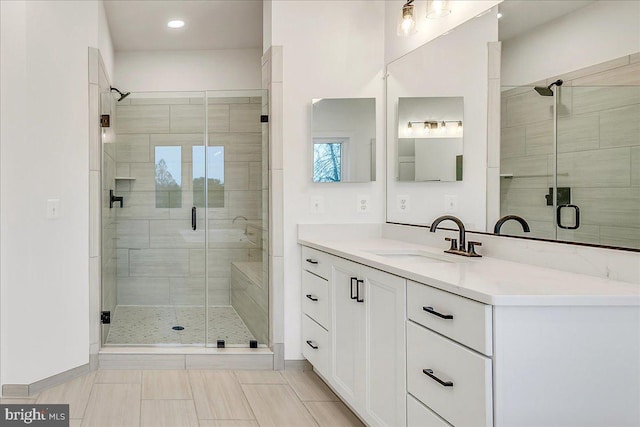 bathroom featuring tile patterned floors, vanity, and walk in shower