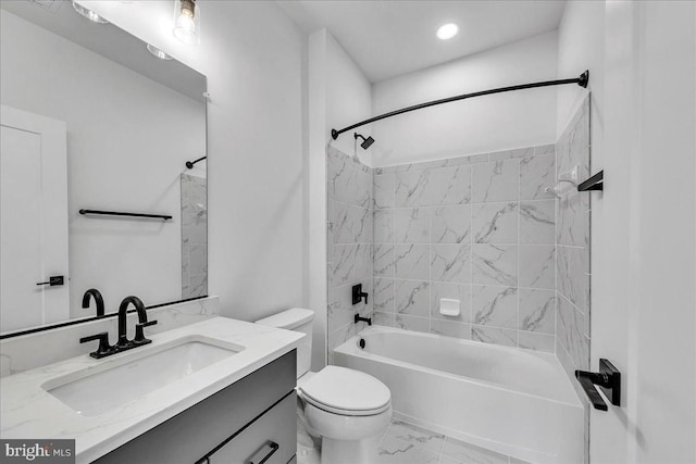 full bathroom featuring vanity, toilet, and tiled shower / bath