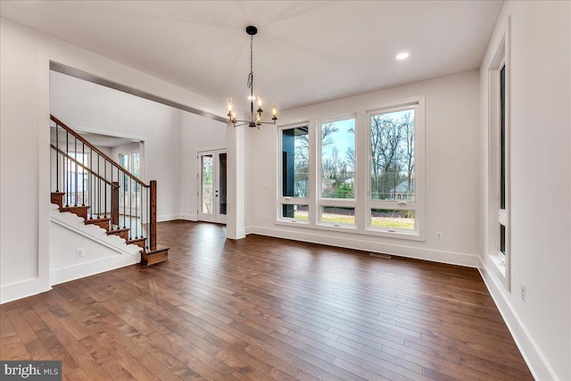 interior space with dark hardwood / wood-style flooring and an inviting chandelier