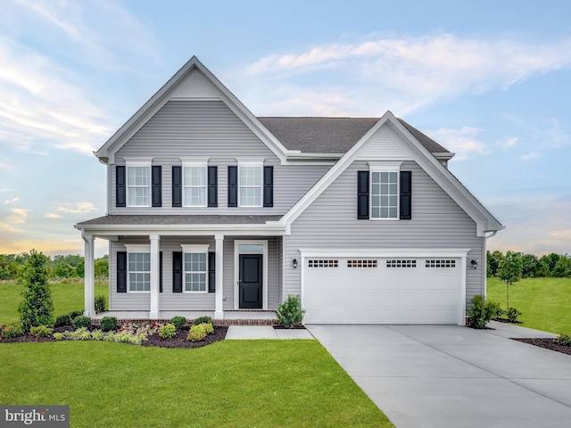 view of front of property featuring a garage and a front yard