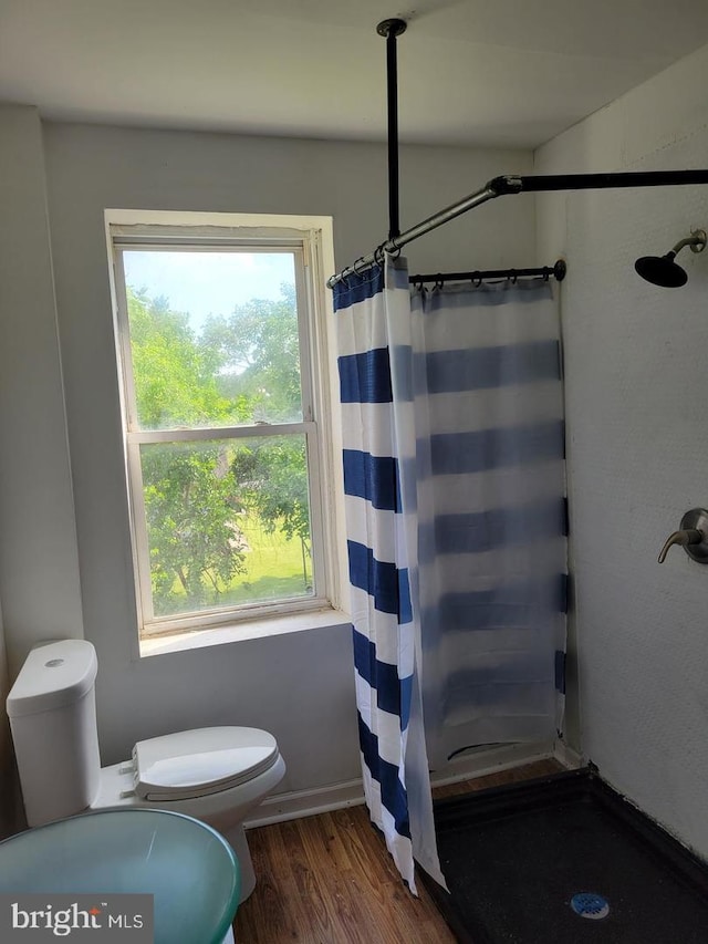 bathroom featuring hardwood / wood-style floors and walk in shower