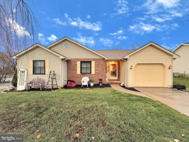 ranch-style home with central AC unit, a garage, and a front yard