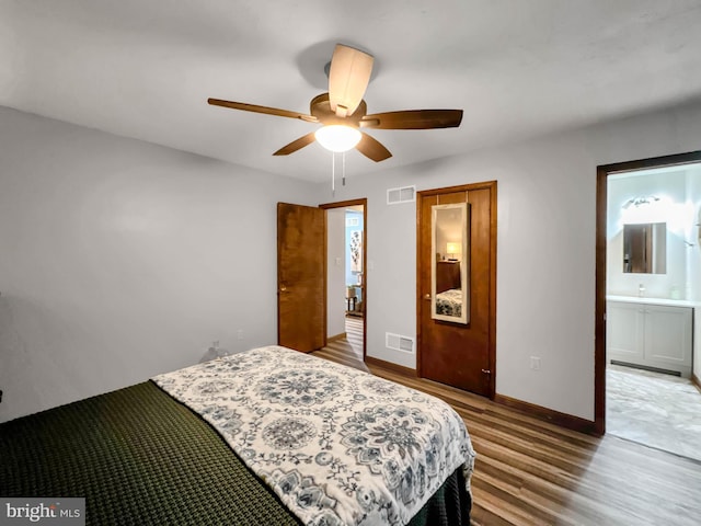 bedroom with hardwood / wood-style floors, ensuite bath, and ceiling fan