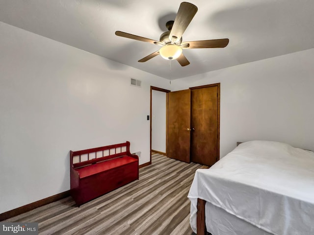 bedroom with hardwood / wood-style floors and ceiling fan