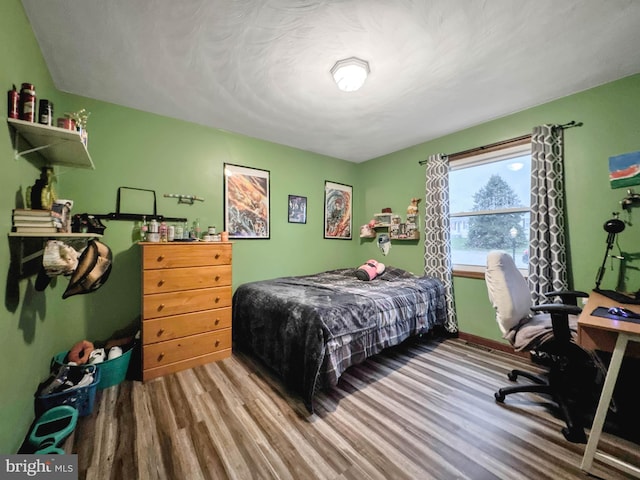 bedroom with wood-type flooring