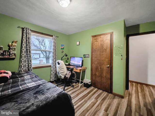 bedroom with hardwood / wood-style floors