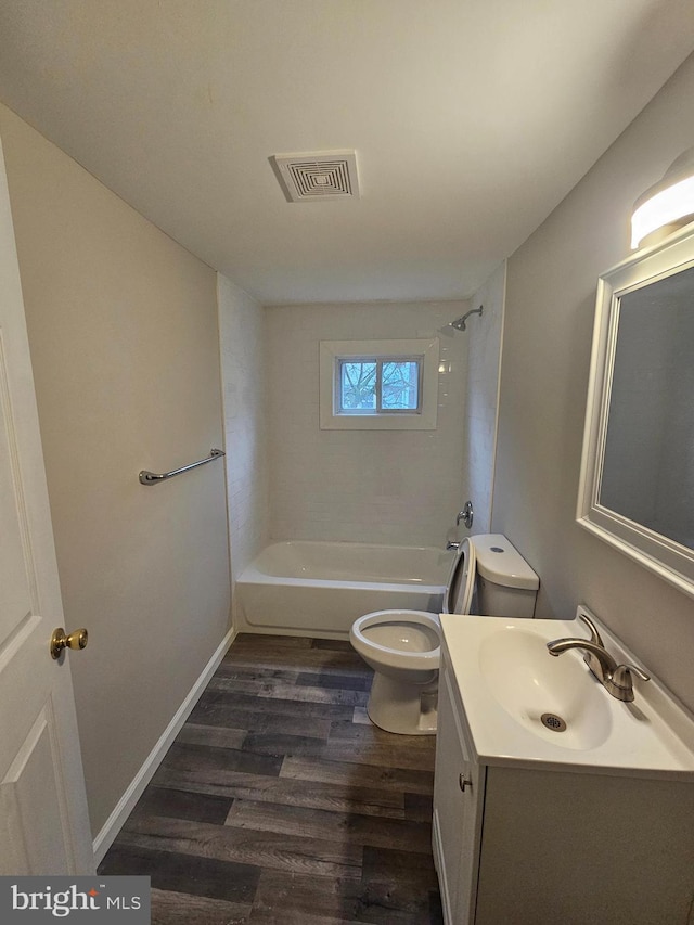 full bathroom featuring vanity, toilet, wood-type flooring, and bathing tub / shower combination