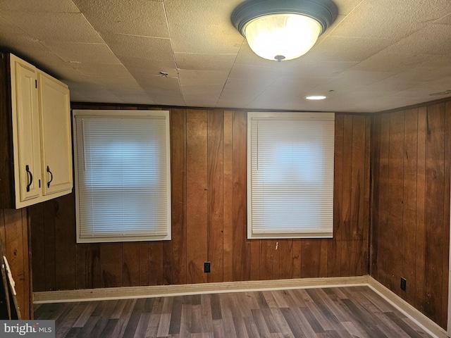 spare room with wooden walls and hardwood / wood-style flooring