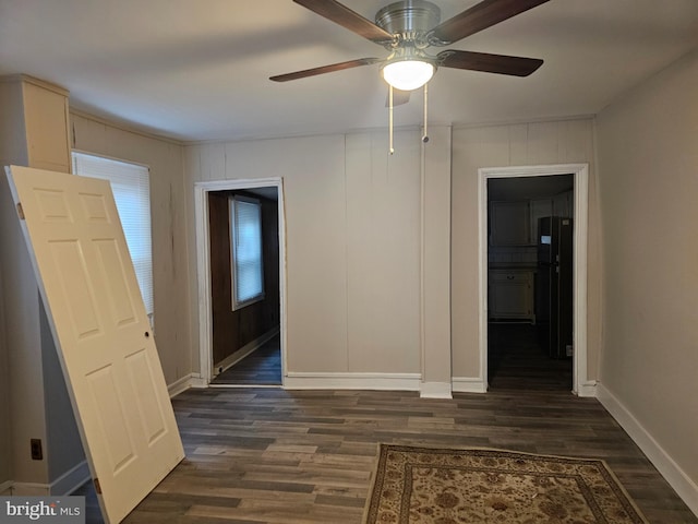 interior space with ceiling fan and dark hardwood / wood-style flooring