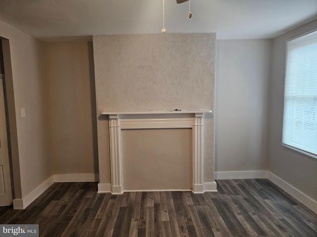 unfurnished living room with dark hardwood / wood-style flooring