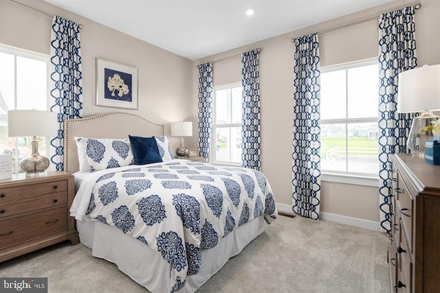 carpeted bedroom with multiple windows