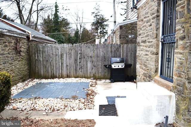 view of patio / terrace with a grill and fence