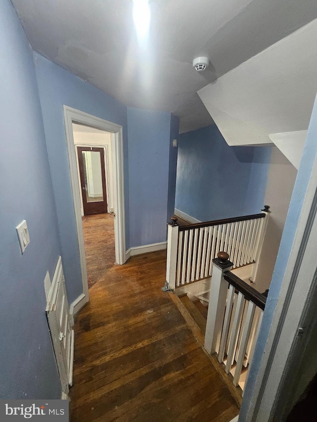 staircase with hardwood / wood-style flooring and baseboards