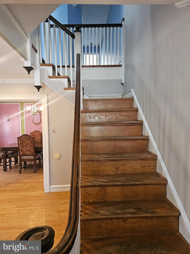 stairway featuring baseboards and wood finished floors