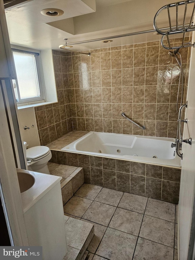 bathroom with tile patterned floors, toilet, and a combined bath / shower with jetted tub