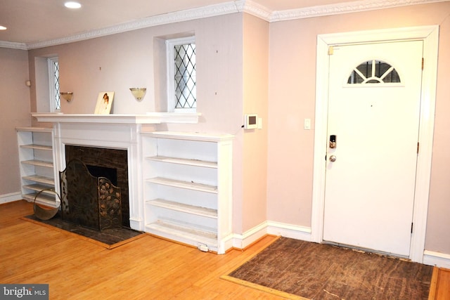 foyer entrance with recessed lighting, baseboards, wood finished floors, and crown molding