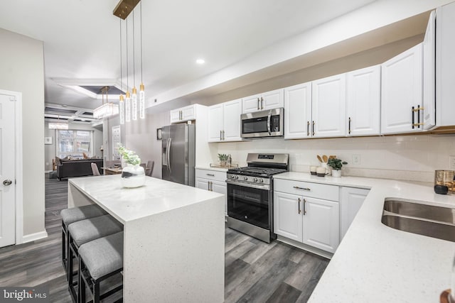 kitchen with white cabinetry, pendant lighting, dark hardwood / wood-style floors, and appliances with stainless steel finishes