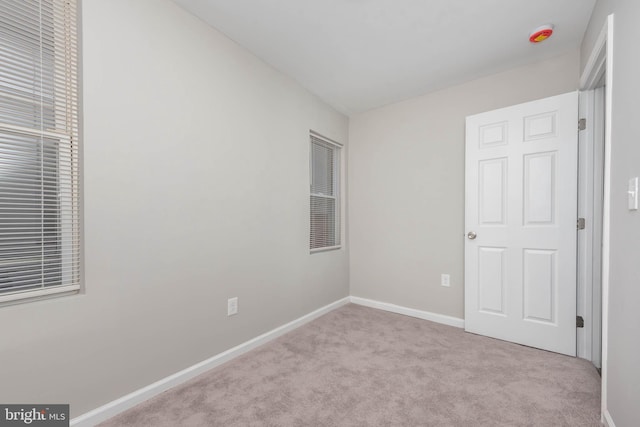 unfurnished bedroom with light colored carpet