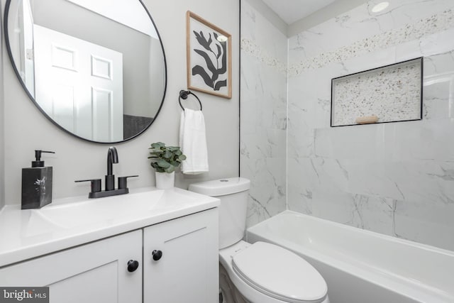 full bathroom with vanity, tiled shower / bath combo, and toilet