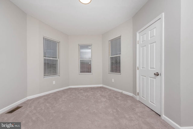 empty room with light colored carpet