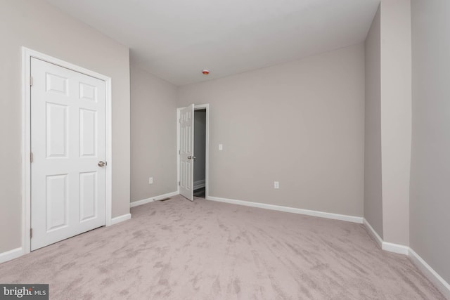 empty room with light colored carpet