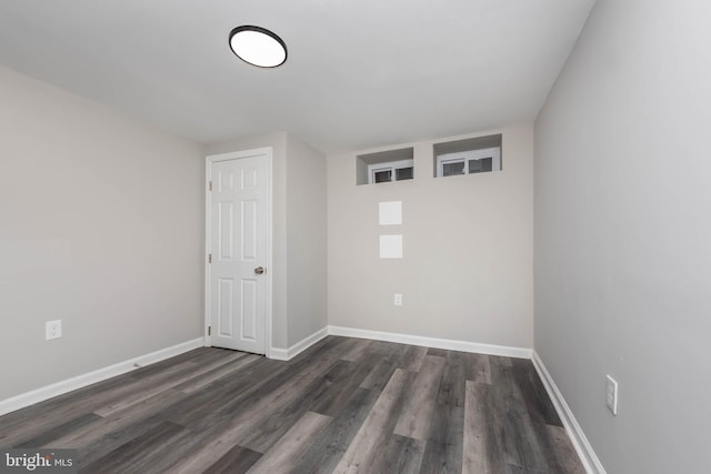 unfurnished room featuring dark hardwood / wood-style flooring