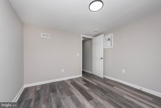 spare room featuring dark hardwood / wood-style floors