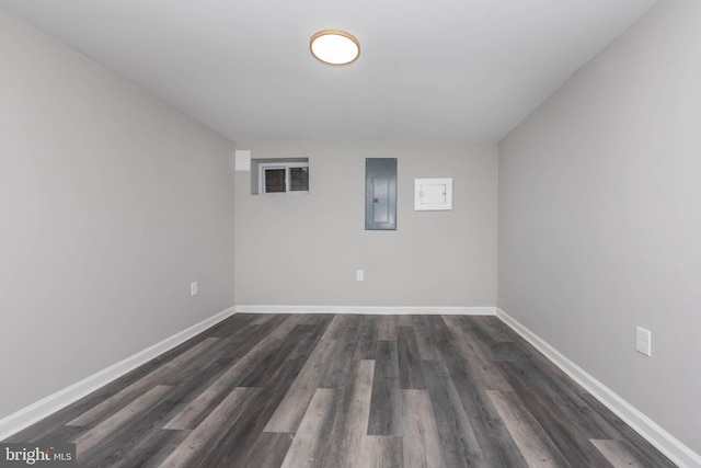 basement featuring dark hardwood / wood-style flooring and electric panel