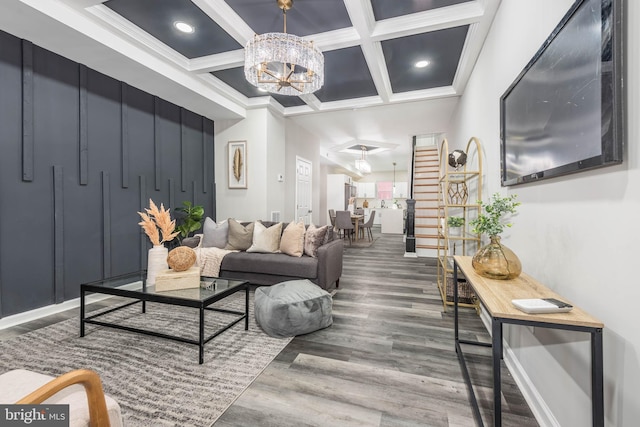 living room with coffered ceiling, crown molding, beam ceiling, hardwood / wood-style flooring, and a chandelier