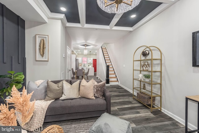 living room featuring a chandelier, beam ceiling, dark hardwood / wood-style floors, and ornamental molding