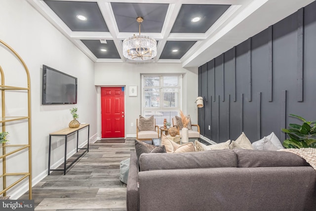 living room with coffered ceiling, an inviting chandelier, crown molding, beam ceiling, and wood-type flooring