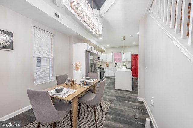 dining area with dark wood-type flooring and sink